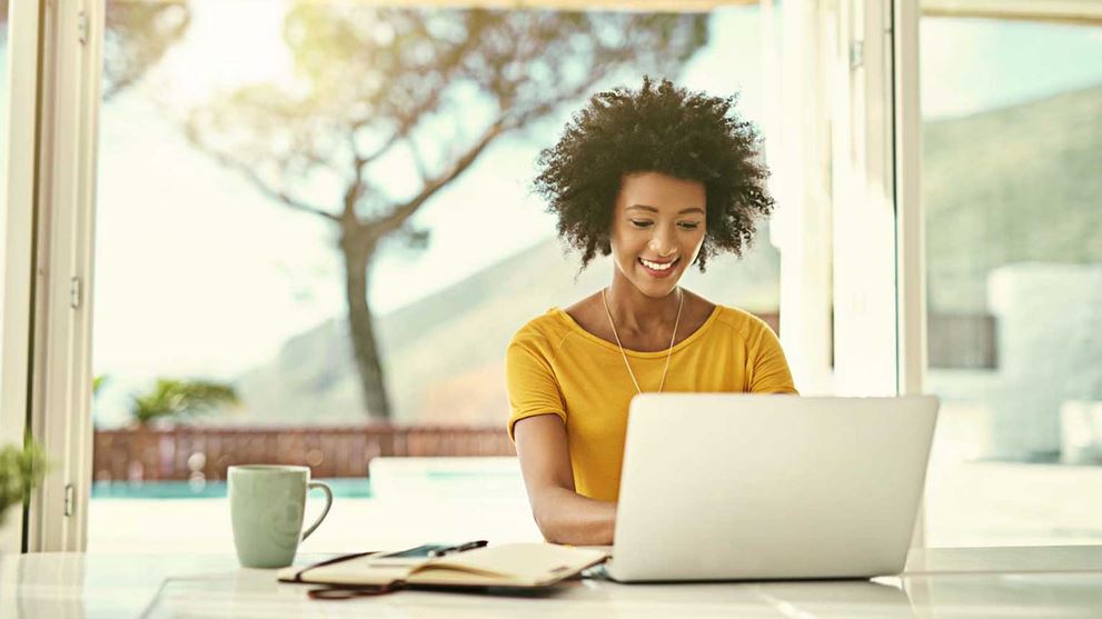 Woman on laptop with folders
