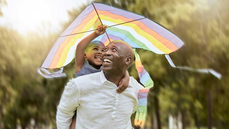 A father and a child flying a kite