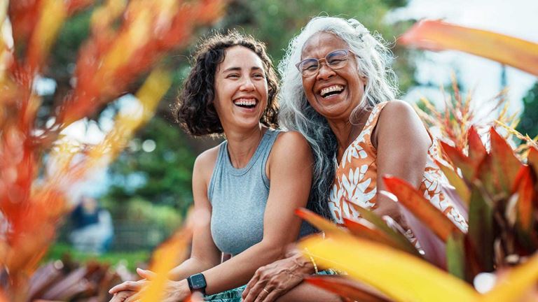 A grandmother and grandaughter laughing together