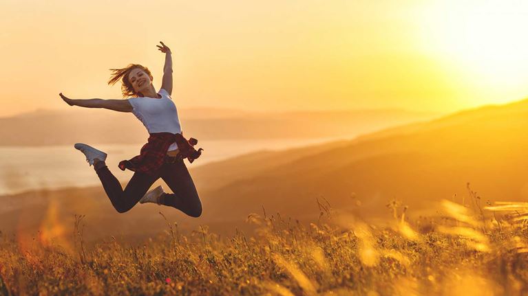Lady-jumping-in-air-in-field