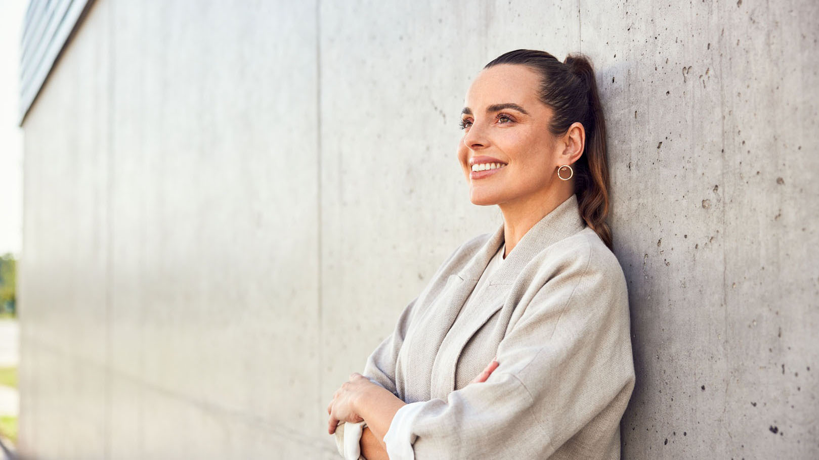Lady leaning against concrete wall