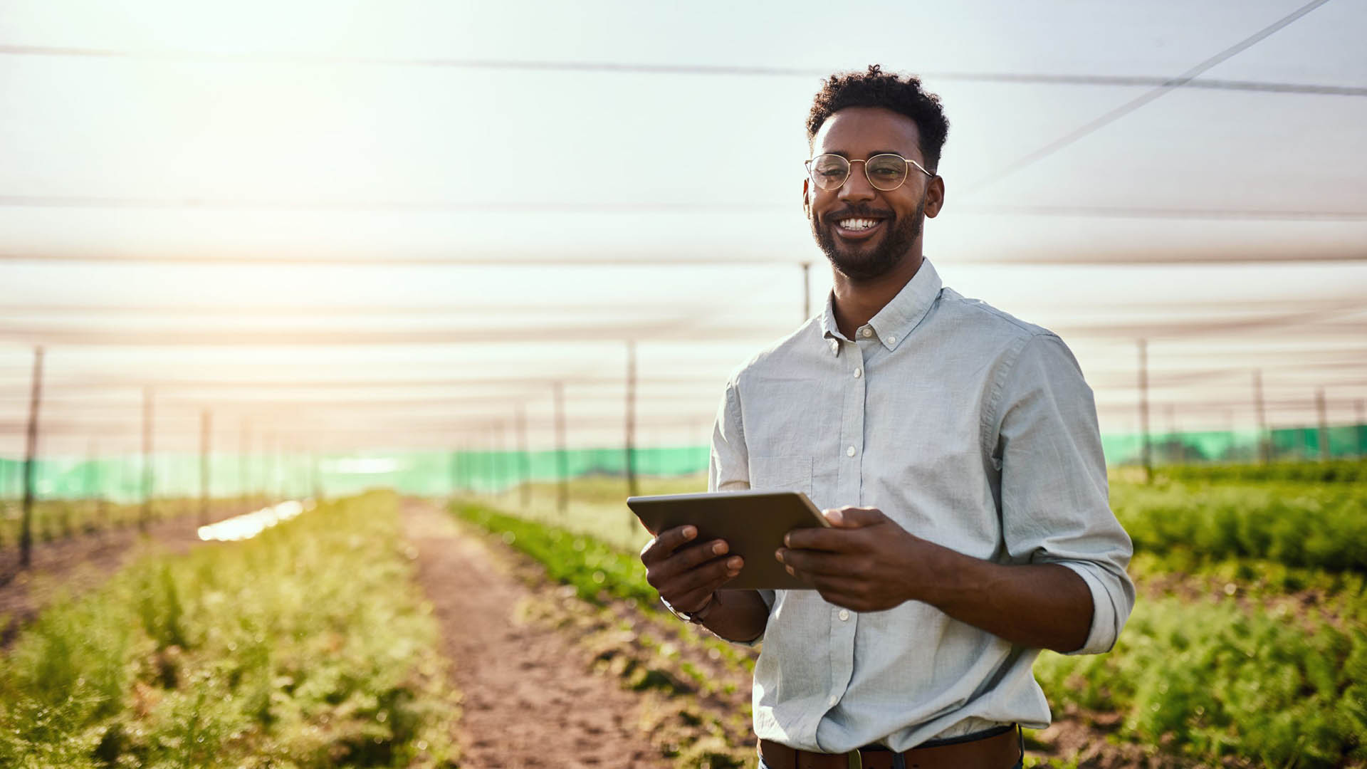 man holding tablet in farm