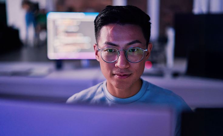 man looking screen in dark