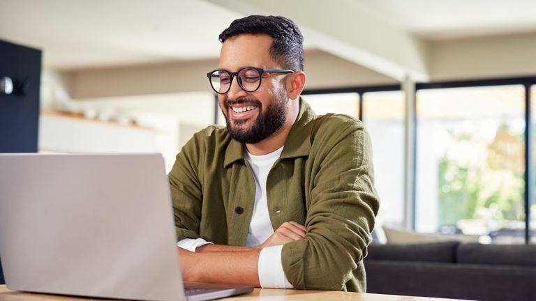 Man smiling at laptop