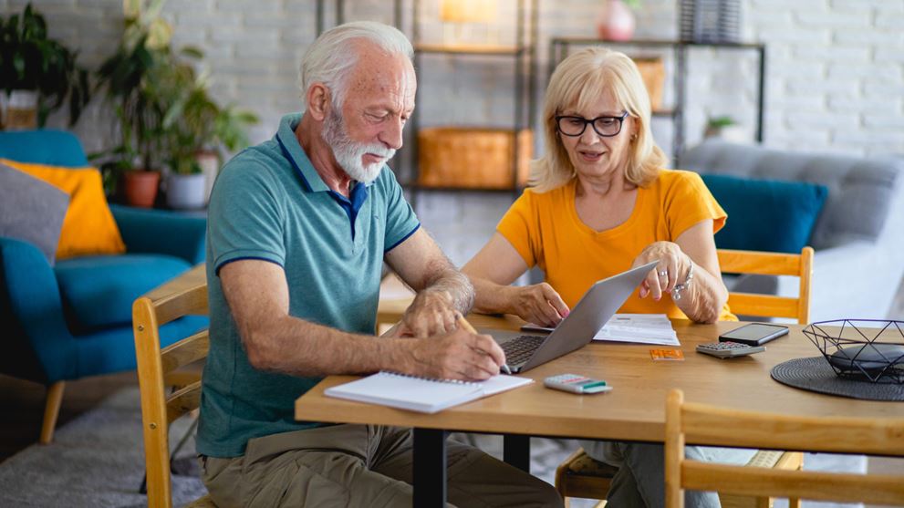 Older couple working on laptop