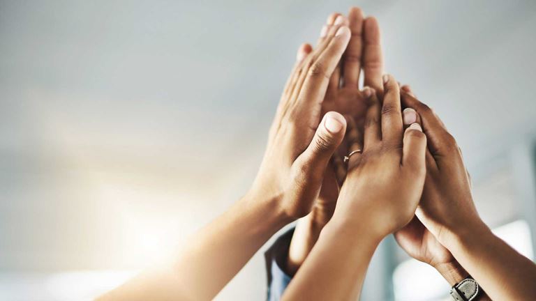 Shot-of-people-hands-in-the-air-together