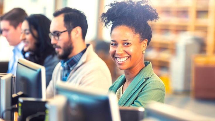 woman at desk smiling