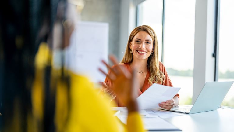 woman in meeting smiling