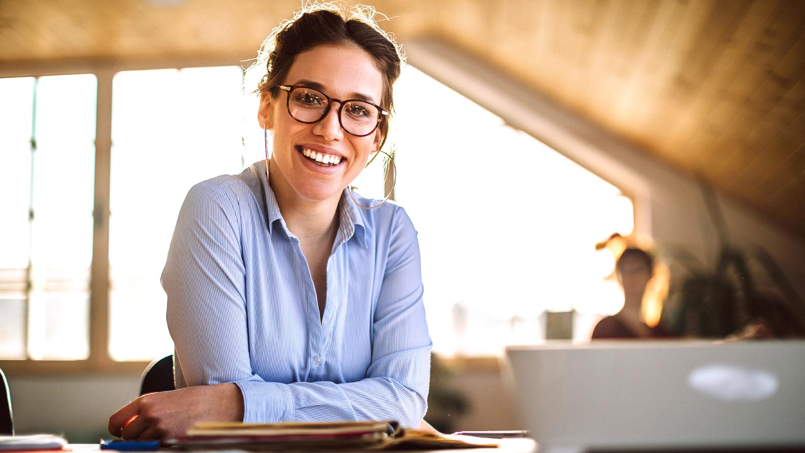 woman smiling at her desk