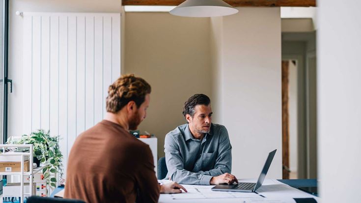 Two men in discussion during a meeting