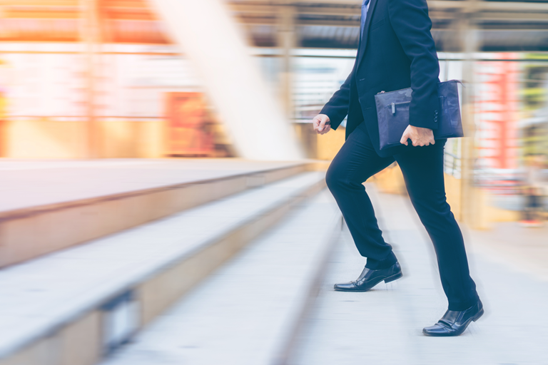 Businessman running up the stair