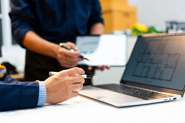 Professionals examining a financial report and supporting records