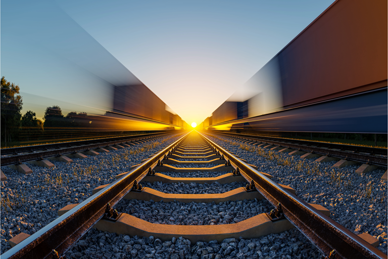 Dramatic perspective motion blur on railway tracks at golden hour