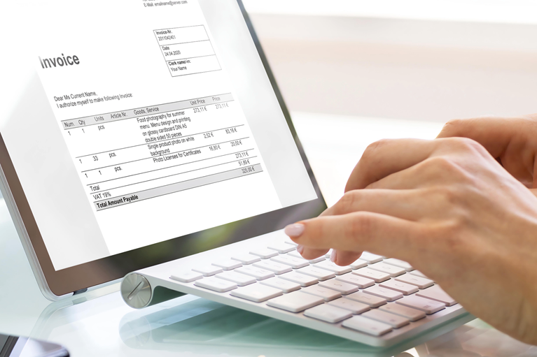 Professional reconciling invoice data to accounting records