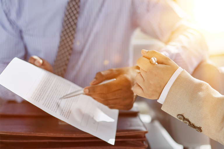 Professionals discussing a proposed business agreement