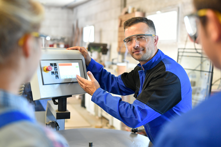 Operational colleague demonstrating a process during handover